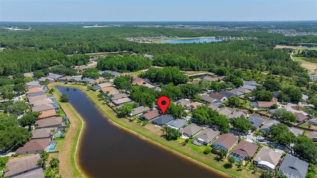 bird's eye view featuring a water view, a view of trees, and a residential view
