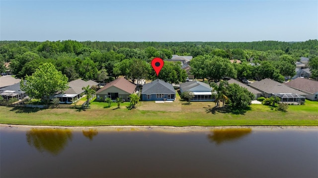 birds eye view of property featuring a water view, a view of trees, and a residential view