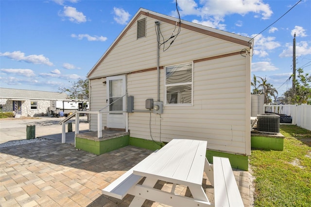 103 146th Ave E, Madeira Beach, FL 33708 - rear view of property featuring central AC, a patio, and fence