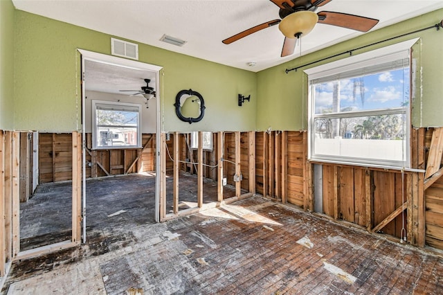 103 146th Ave E, Madeira Beach, FL 33708 - empty room featuring wood walls, a wainscoted wall, and visible vents