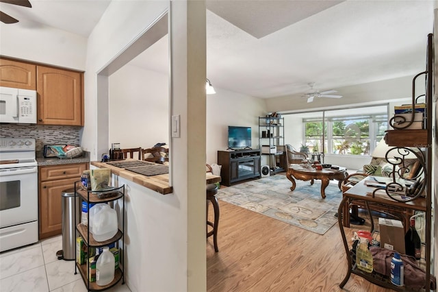 9945 47th Ave N Unit 208, Saint Petersburg, FL 33708 - kitchen featuring white appliances, ceiling fan, backsplash, and open floor plan