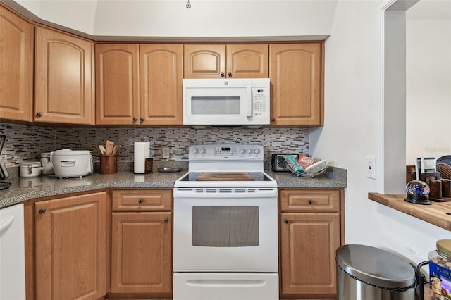 9945 47th Ave N Unit 208, Saint Petersburg, FL 33708 - kitchen featuring white appliances and decorative backsplash