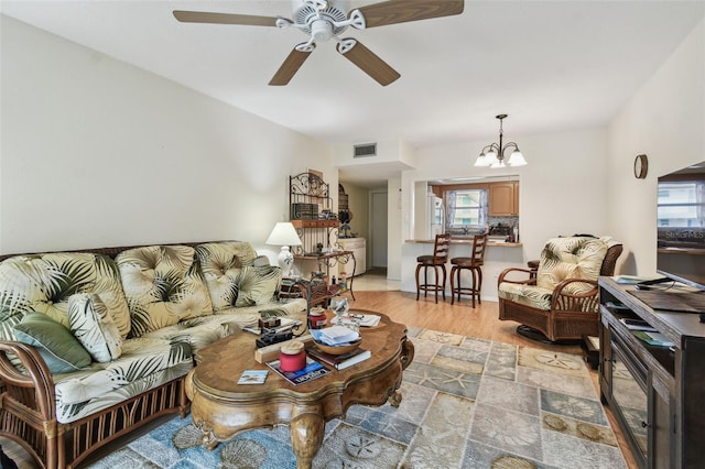9945 47th Ave N Unit 208, Saint Petersburg, FL 33708 - living area featuring a ceiling fan, a chandelier, and light wood-type flooring