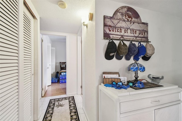 9945 47th Ave N Unit 208, Saint Petersburg, FL 33708 - hallway with light tile patterned floors and a textured ceiling