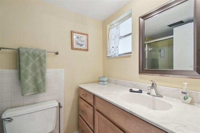 9945 47th Ave N Unit 208, Saint Petersburg, FL 33708 - full bathroom with vanity, toilet, tile walls, and an enclosed shower