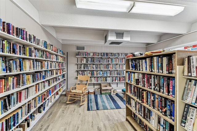 9945 47th Ave N Unit 208, Saint Petersburg, FL 33708 - living area featuring wall of books and wood finished floors