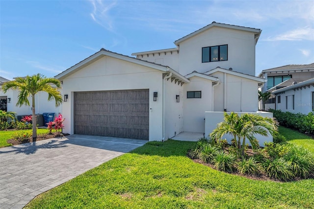 5917 Cat Claw Ln, Bradenton, FL 34210 - view of front facade with a garage, a front yard, stucco siding, and decorative driveway