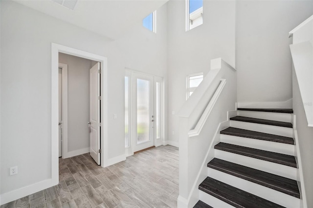5917 Cat Claw Ln, Bradenton, FL 34210 - foyer with baseboards, a high ceiling, stairs, and plenty of natural light