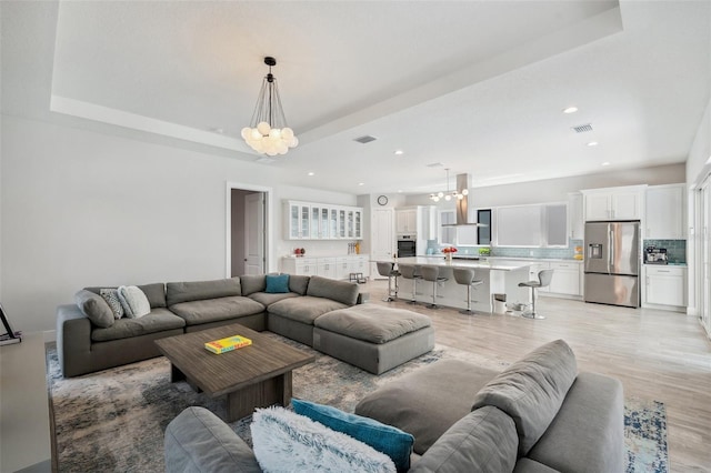 5917 Cat Claw Ln, Bradenton, FL 34210 - living room featuring recessed lighting, a notable chandelier, visible vents, and light wood-type flooring