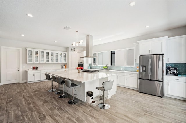 5917 Cat Claw Ln, Bradenton, FL 34210 - kitchen featuring white cabinets, stainless steel appliances, and island range hood