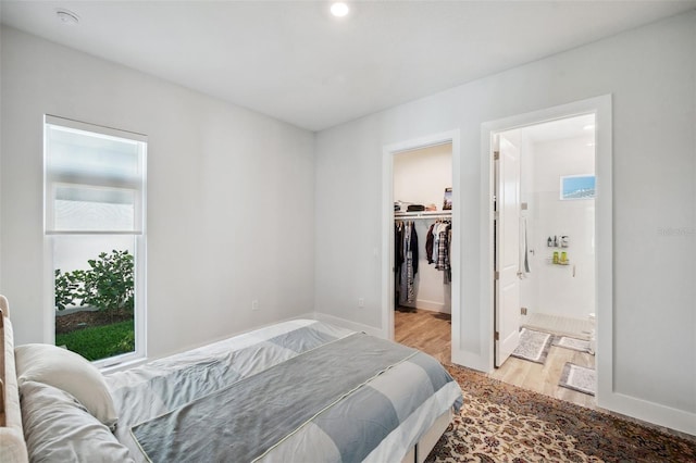 5917 Cat Claw Ln, Bradenton, FL 34210 - bedroom with ensuite bathroom, a spacious closet, light wood-style flooring, baseboards, and recessed lighting