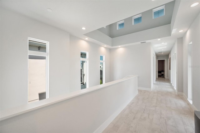 5917 Cat Claw Ln, Bradenton, FL 34210 - corridor with light wood-style flooring, baseboards, recessed lighting, and an upstairs landing
