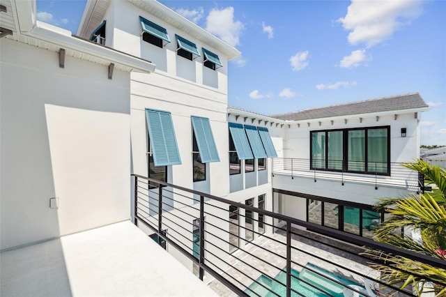5917 Cat Claw Ln, Bradenton, FL 34210 - rear view of house with a balcony and stucco siding