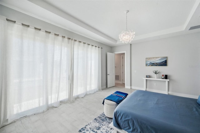 5917 Cat Claw Ln, Bradenton, FL 34210 - bedroom with an inviting chandelier, visible vents, and a raised ceiling
