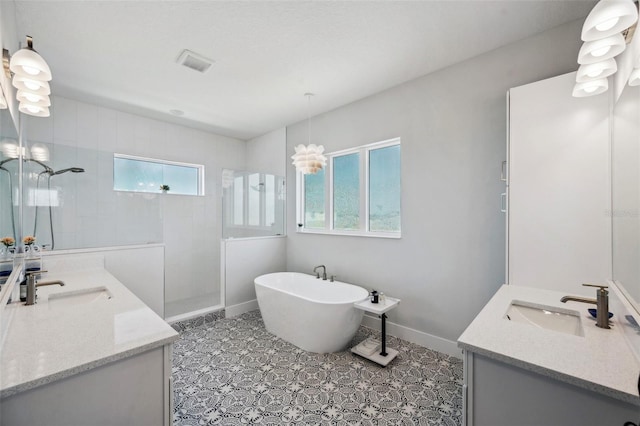 5917 Cat Claw Ln, Bradenton, FL 34210 - full bath featuring two vanities, a wealth of natural light, walk in shower, and a sink