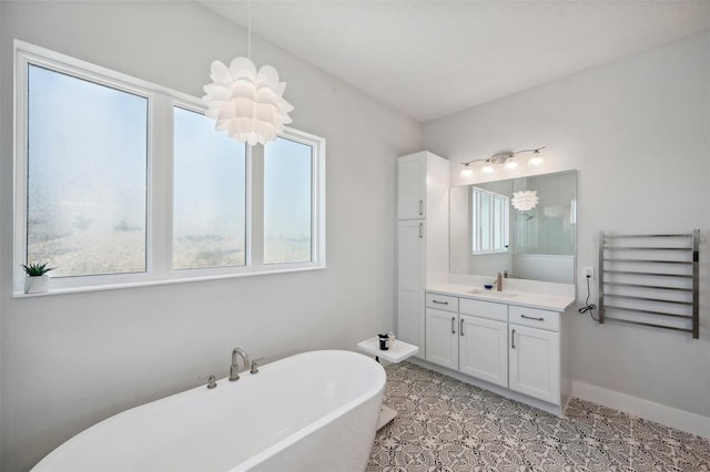 5917 Cat Claw Ln, Bradenton, FL 34210 - full bathroom with a freestanding bath, radiator heating unit, vanity, and plenty of natural light