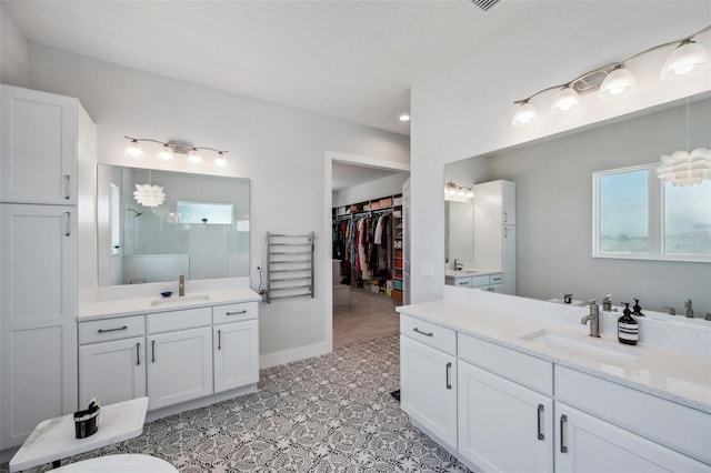 5917 Cat Claw Ln, Bradenton, FL 34210 - bathroom with two vanities, a sink, a walk in shower, and baseboards