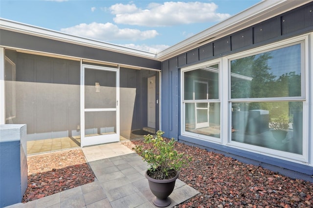 view of exterior entry with board and batten siding