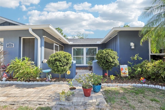 view of property exterior with a patio and board and batten siding