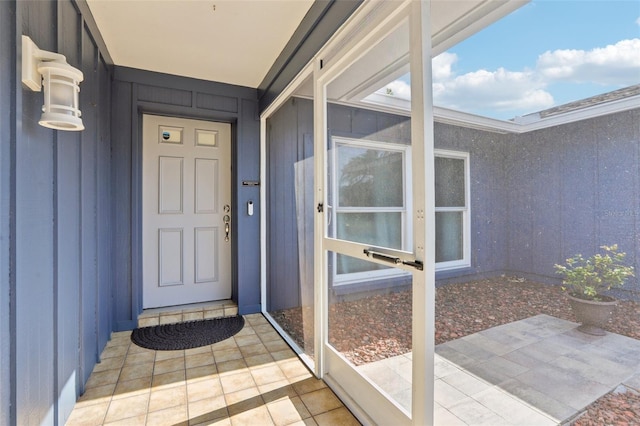 view of exterior entry featuring board and batten siding