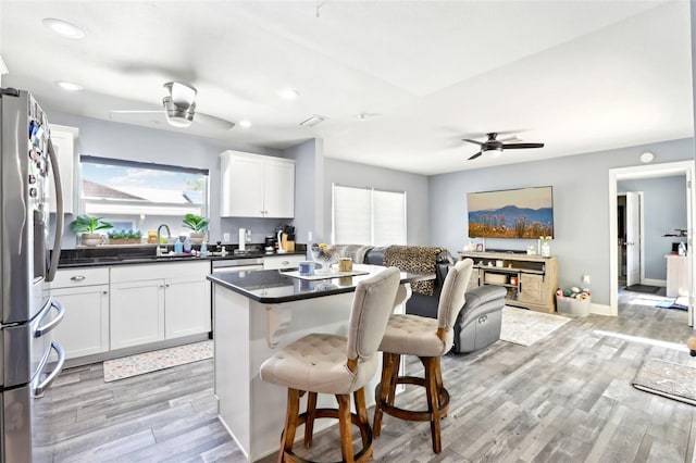 kitchen with a ceiling fan, freestanding refrigerator, and a wealth of natural light