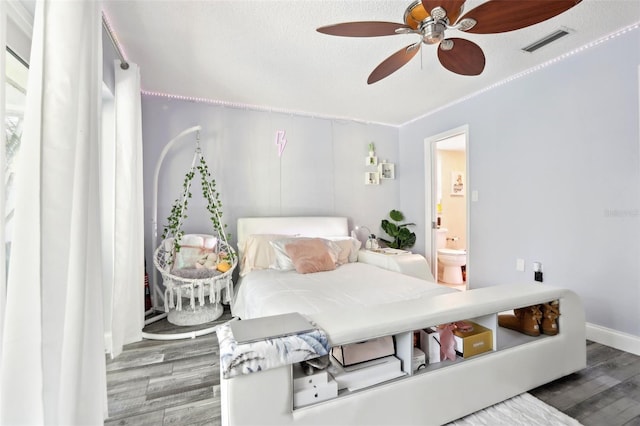 bedroom featuring connected bathroom, visible vents, ceiling fan, and wood finished floors