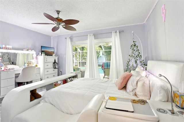bedroom with access to exterior, ceiling fan, and a textured ceiling