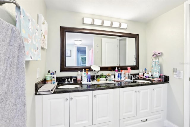 full bath featuring double vanity and a sink