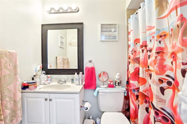 bathroom with vanity, toilet, and curtained shower