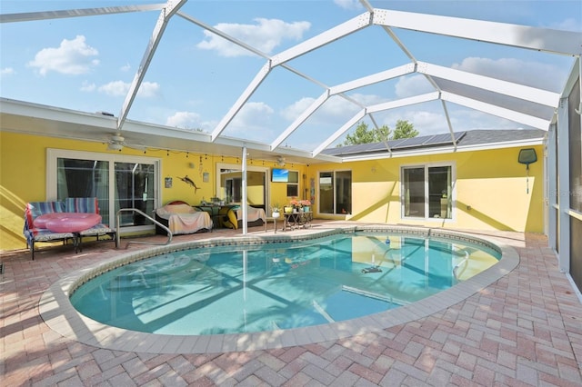 outdoor pool featuring a patio, ceiling fan, and a lanai