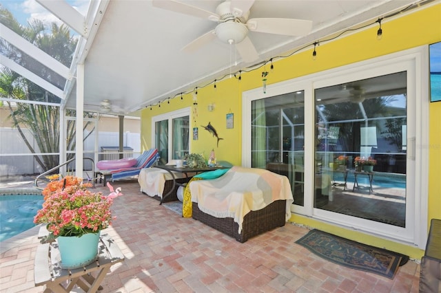 view of patio / terrace featuring a lanai, ceiling fan, an outdoor pool, and fence
