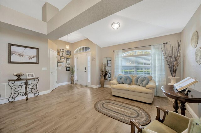 living area featuring light wood finished floors and baseboards