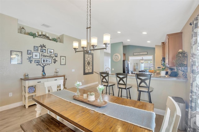 dining area with recessed lighting, lofted ceiling, visible vents, light wood-style floors, and baseboards