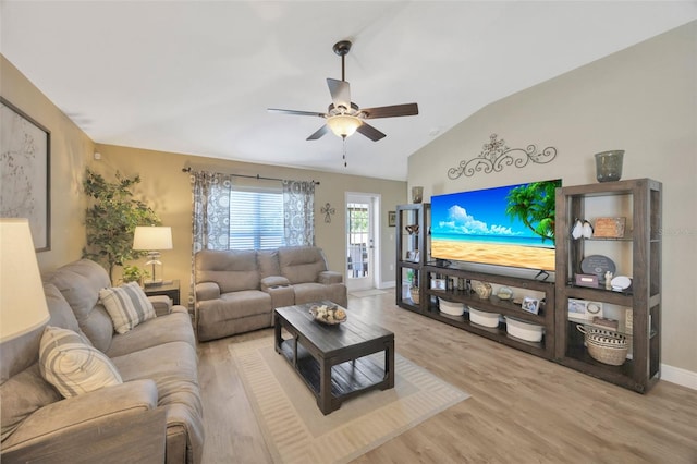 living area with vaulted ceiling, a ceiling fan, wood finished floors, and baseboards