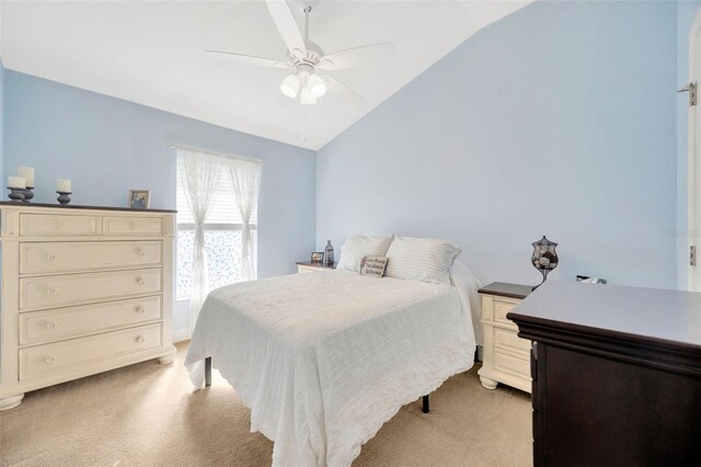 bedroom featuring lofted ceiling, light colored carpet, and ceiling fan