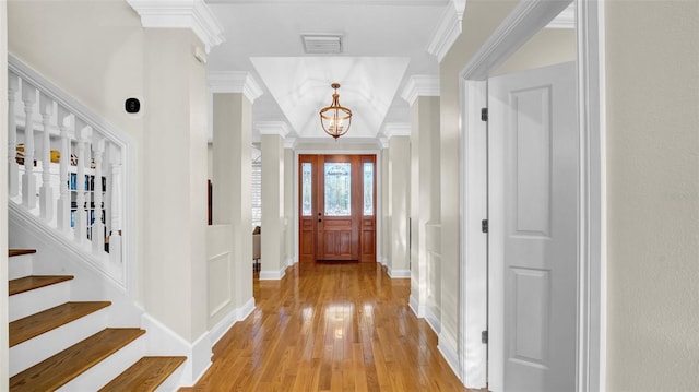 10101 Bryant Rd, Lithia, FL 33547 - entrance foyer featuring crown molding, a chandelier, light wood-style flooring, and stairs