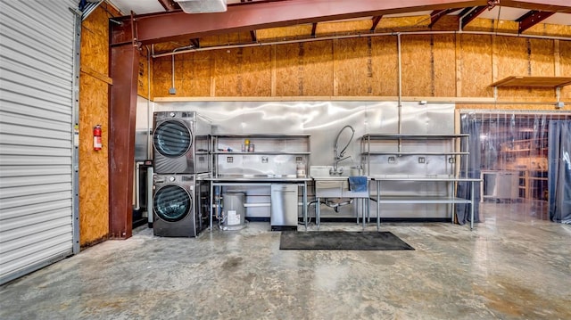 10101 Bryant Rd, Lithia, FL 33547 - garage with stacked washer / drying machine and wooden walls