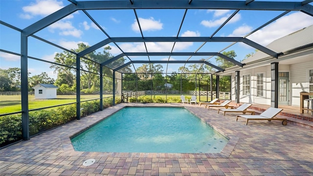 10101 Bryant Rd, Lithia, FL 33547 - swimming pool featuring a patio, a lanai, a shed, and a lawn