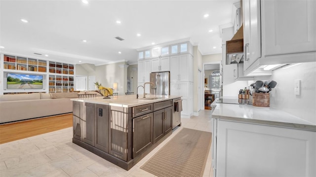 10101 Bryant Rd, Lithia, FL 33547 - kitchen featuring appliances with stainless steel finishes, white cabinetry, built in shelves, ornamental molding, and a kitchen island with sink