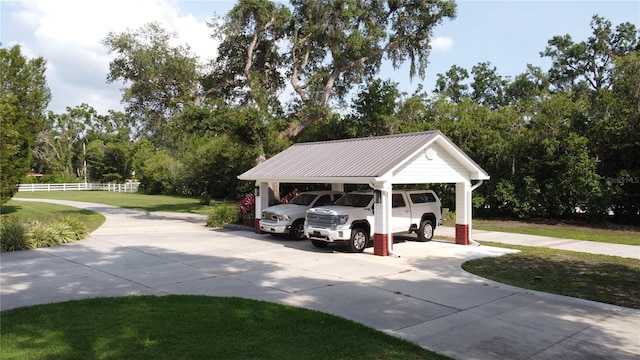 10101 Bryant Rd, Lithia, FL 33547 - view of car parking featuring a carport, driveway, and view of scattered trees