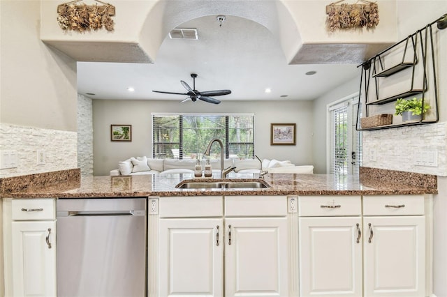 kitchen featuring stainless steel dishwasher, ceiling fan, a sink, visible vents, and open floor plan