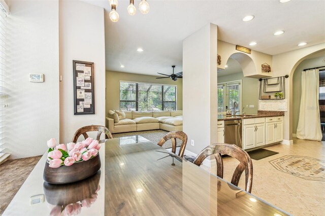 dining room with baseboards, recessed lighting, arched walkways, and ceiling fan