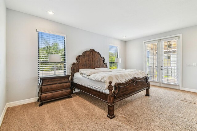 bedroom with recessed lighting, access to outside, light colored carpet, and baseboards
