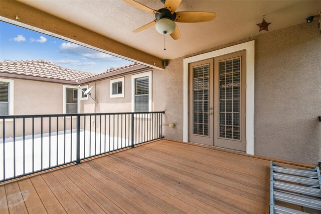 wooden deck with ceiling fan and french doors