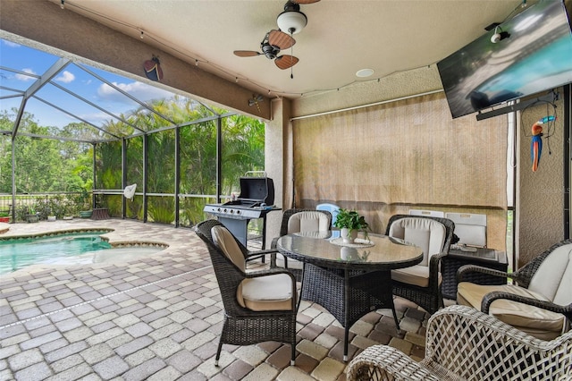 view of patio / terrace with a lanai, ceiling fan, outdoor dining space, and an outdoor pool