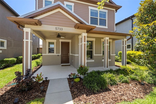 entrance to property with ceiling fan and covered porch