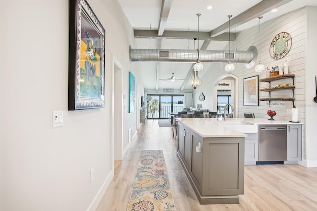7540 Sunshine Skyway Ln S Unit 217, Saint Petersburg, FL 33711 - kitchen featuring gray cabinets, stainless steel dishwasher, a sink, beamed ceiling, and light wood-style flooring