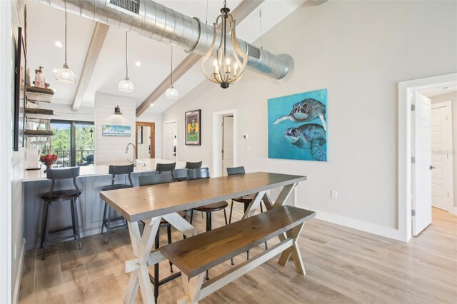 7540 Sunshine Skyway Ln S Unit 217, Saint Petersburg, FL 33711 - dining area featuring visible vents, wood finished floors, baseboards, beamed ceiling, and an inviting chandelier