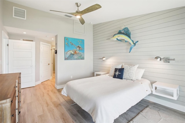 7540 Sunshine Skyway Ln S Unit 217, Saint Petersburg, FL 33711 - bedroom with wooden walls, a ceiling fan, baseboards, wood finished floors, and visible vents