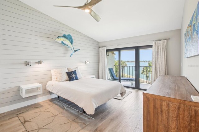 7540 Sunshine Skyway Ln S Unit 217, Saint Petersburg, FL 33711 - bedroom featuring ceiling fan, vaulted ceiling, wood finished floors, wooden walls, and access to outside